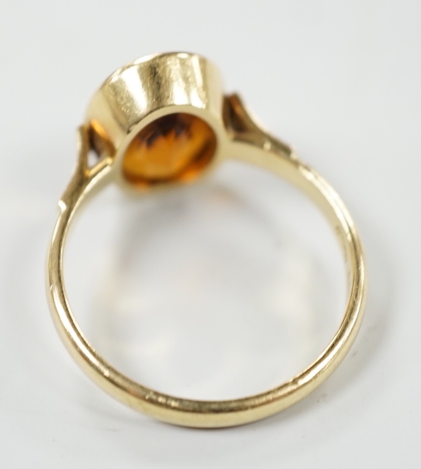 A George V 750 yellow metal and oval cut citrine set ring, size Q, gross weight 5.6 grams.